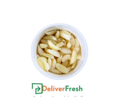 Peeled garlic in a white bowl with 'Deliver Fresh'