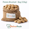 Fresh brushed potatoes packed in a 15kg burlap bag on a pure white background by DeliverFresh