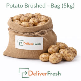 Fresh brushed potatoes packed in a 5kg burlap bag on a pure white background by DeliverFresh